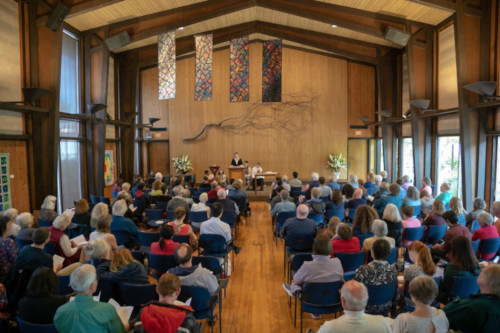 Interior of the Main Hall at the Unitarian Universalist Church of Palo Alto, looking from the back over the heads of the congregation